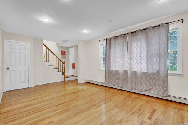 unfurnished room featuring light hardwood / wood-style flooring and plenty of natural light