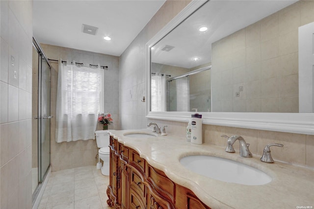 bathroom featuring tile patterned flooring, toilet, tile walls, and an enclosed shower