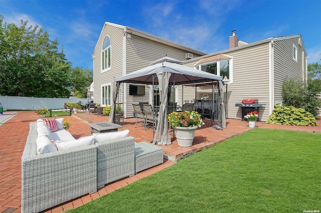 back of property with outdoor lounge area, a yard, and a patio