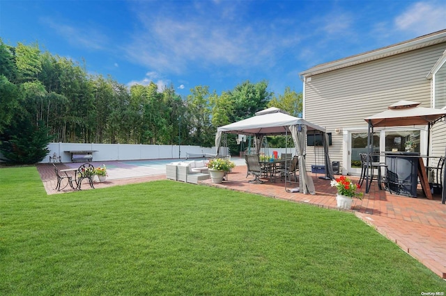 view of yard featuring a gazebo, an outdoor hangout area, and a patio area