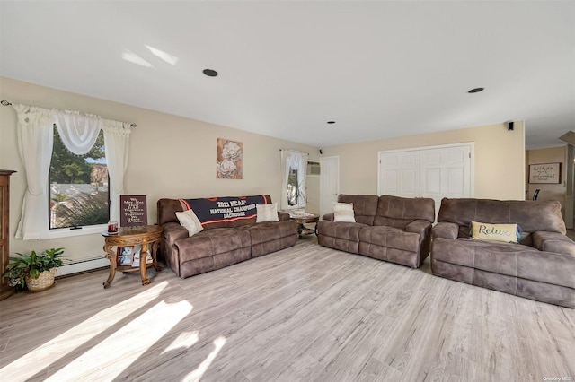 living room with light hardwood / wood-style flooring and baseboard heating