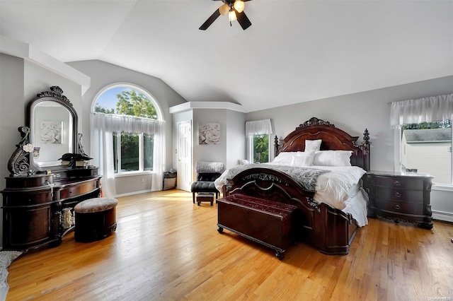 bedroom with light wood-type flooring, ceiling fan, and lofted ceiling