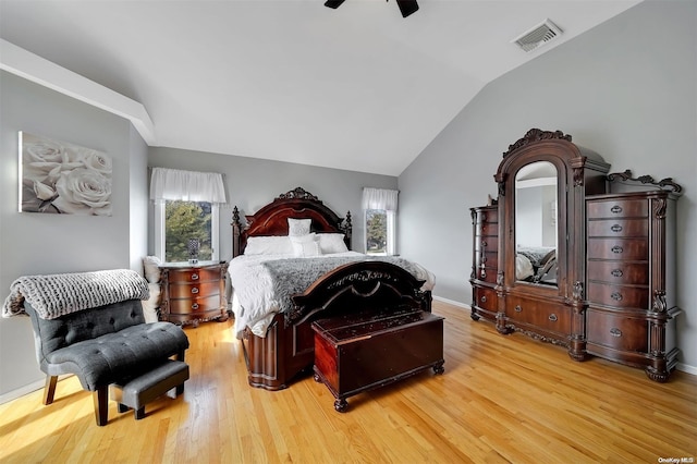 bedroom with ceiling fan, hardwood / wood-style floors, and lofted ceiling