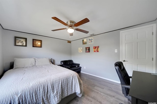 bedroom with wood-type flooring and ceiling fan