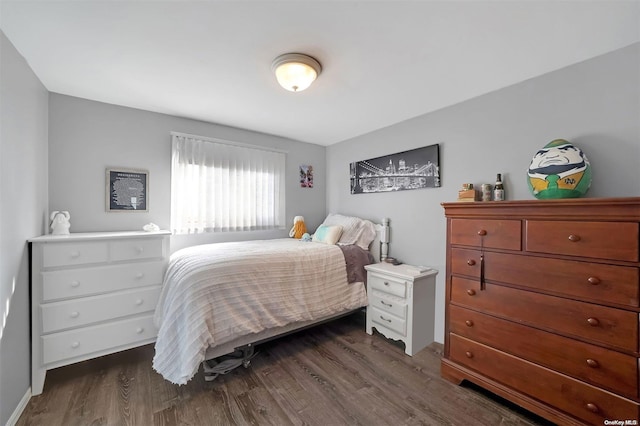 bedroom with dark hardwood / wood-style flooring