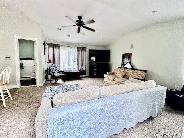 bedroom featuring ceiling fan, light carpet, and lofted ceiling