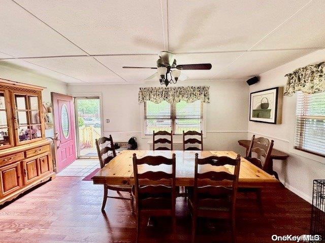 dining room with ceiling fan and wood-type flooring