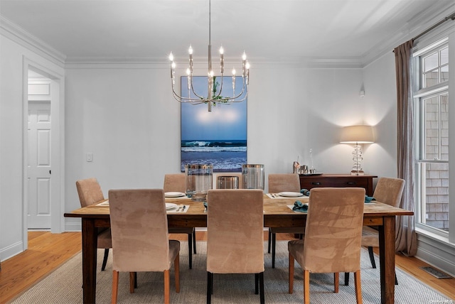 dining space featuring light hardwood / wood-style floors and ornamental molding