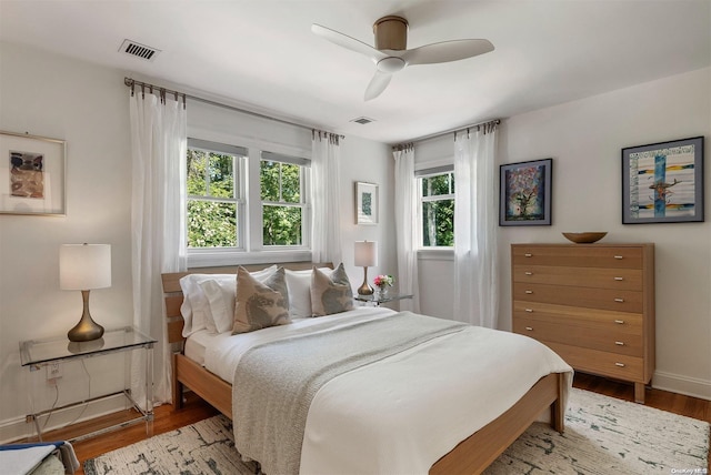 bedroom with ceiling fan and light hardwood / wood-style flooring