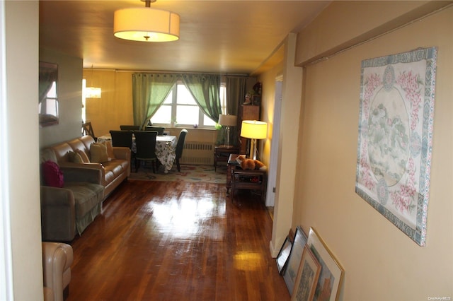 living room with radiator and dark wood-type flooring