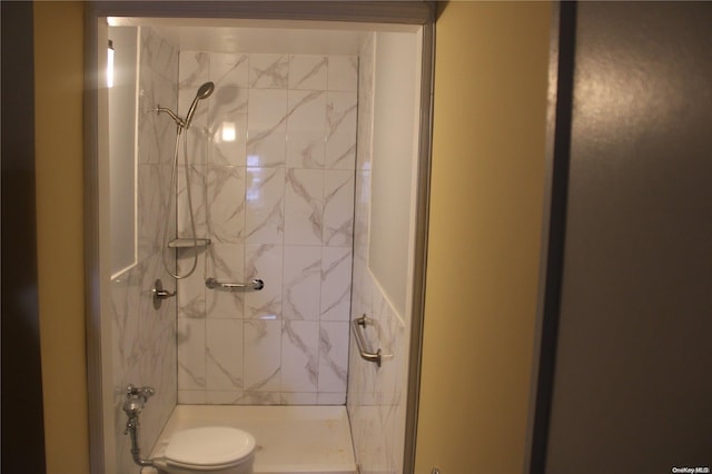 bathroom with tiled shower and toilet