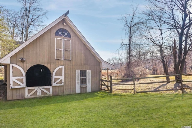 view of outbuilding featuring a yard