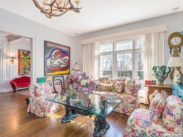 interior space featuring a baseboard heating unit, dark hardwood / wood-style floors, and a notable chandelier