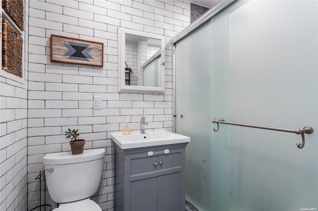 bathroom with vanity, toilet, and an enclosed shower