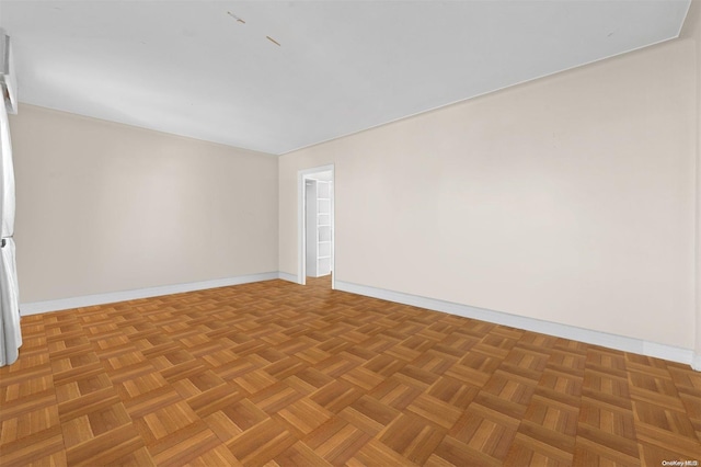 unfurnished room featuring parquet floors