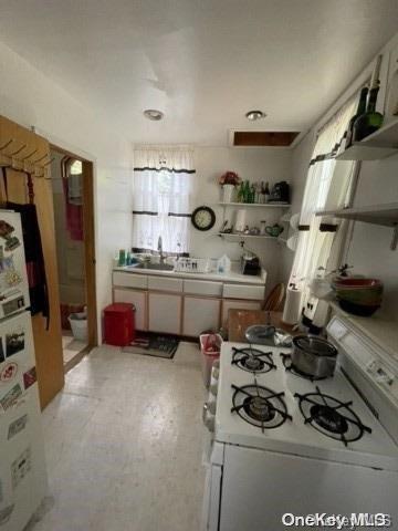 kitchen featuring white appliances and sink