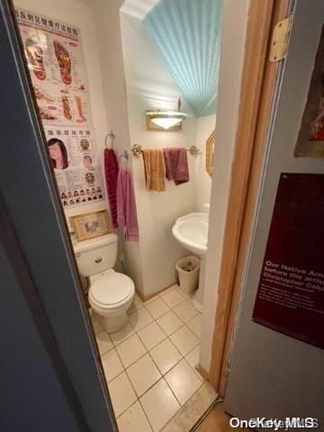 bathroom featuring tile patterned flooring and toilet