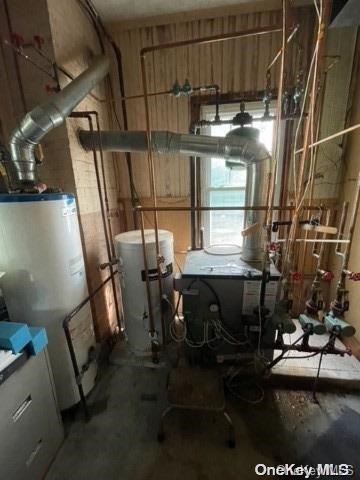 utility room featuring water heater