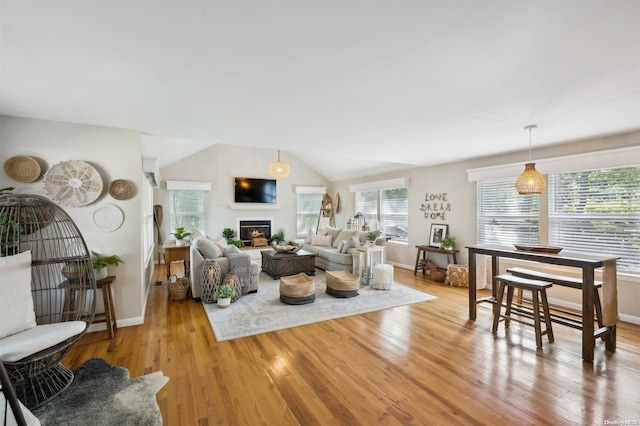 living room featuring light hardwood / wood-style floors and lofted ceiling