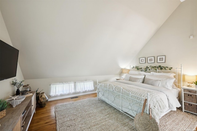 bedroom featuring hardwood / wood-style flooring and vaulted ceiling