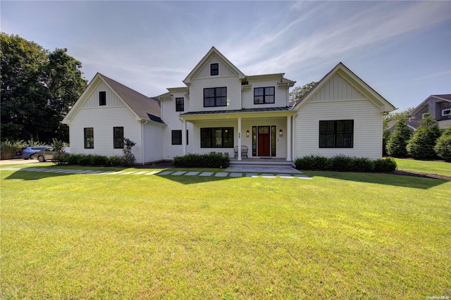 modern inspired farmhouse with a porch and a front lawn