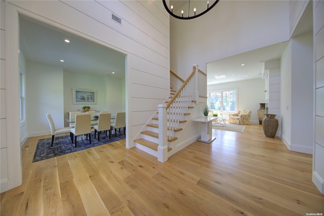 151 Newtown Ln, East Hampton, NY 11937 - entryway with stairs, light wood-style flooring, a chandelier, recessed lighting, and baseboards