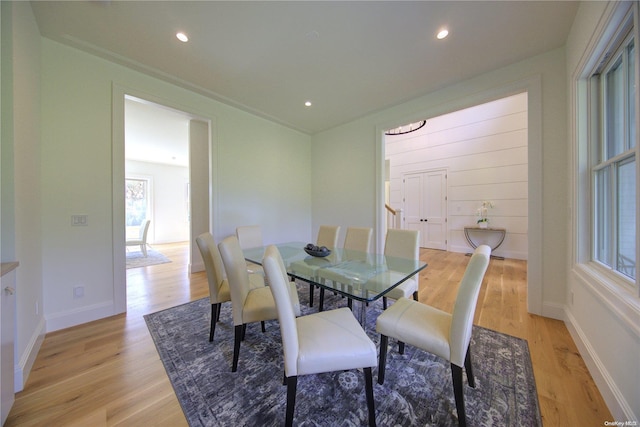 dining area with crown molding and light hardwood / wood-style flooring