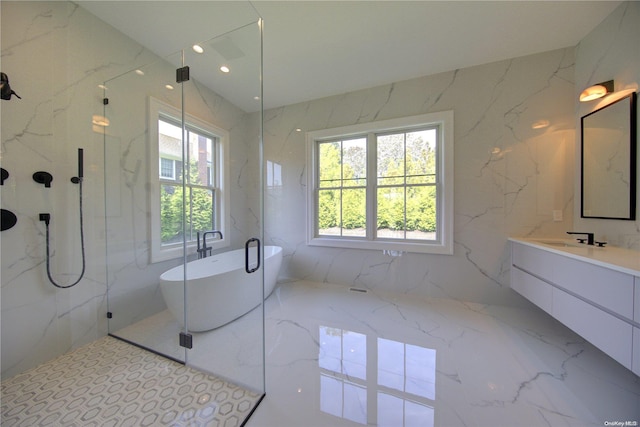 bathroom with vanity, separate shower and tub, and tile walls