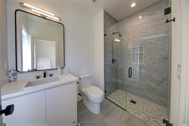 151 Newtown Ln, East Hampton, NY 11937 - full bath featuring toilet, a shower stall, vanity, recessed lighting, and wood finished floors