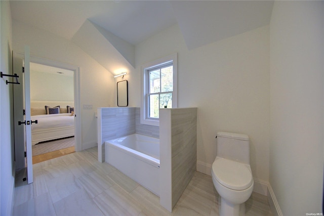 bathroom featuring tile patterned floors, toilet, and a bath