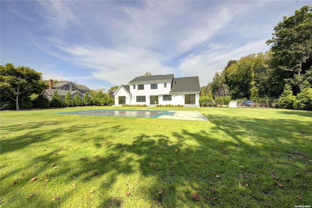 rear view of house with a patio area and a yard