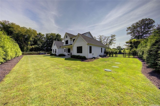 view of side of property with a yard