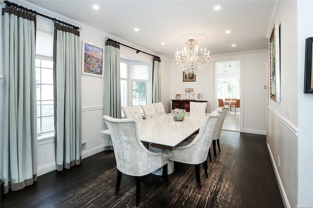 dining area with a notable chandelier, dark hardwood / wood-style floors, and crown molding