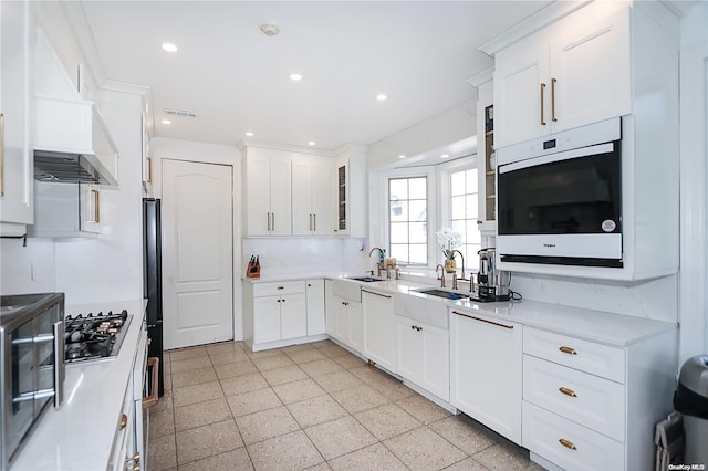 kitchen featuring white cabinetry, sink, and stainless steel gas cooktop