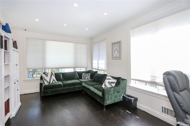 living room with a wealth of natural light, dark wood-type flooring, and ornamental molding