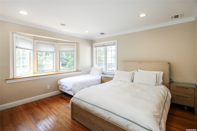 bedroom featuring dark hardwood / wood-style floors and crown molding