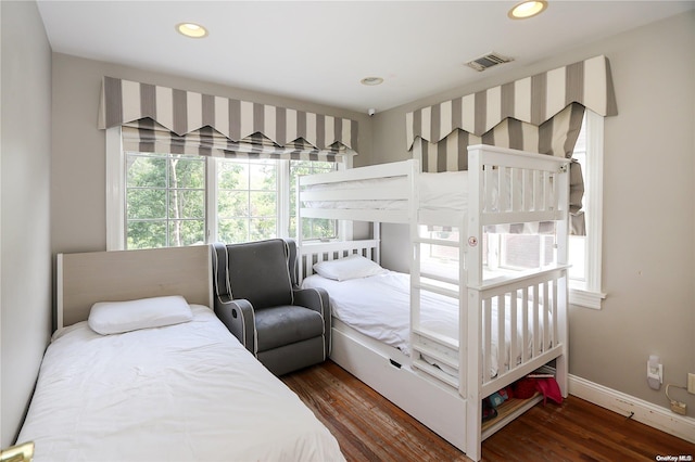 bedroom featuring dark hardwood / wood-style floors and multiple windows