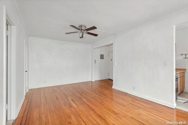 spare room with light hardwood / wood-style flooring and ceiling fan