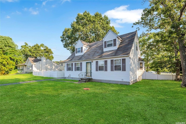 cape cod home with a front yard