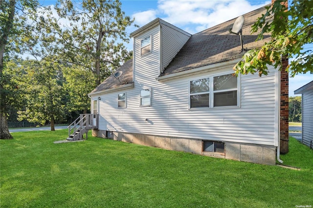 view of side of property with a yard