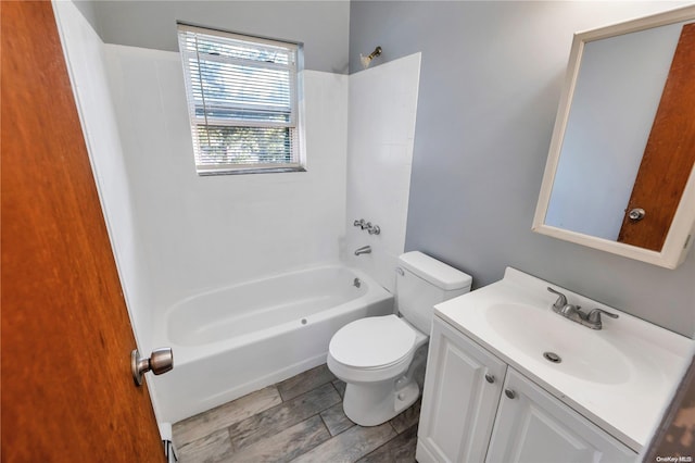 full bathroom featuring hardwood / wood-style floors, vanity,  shower combination, and toilet