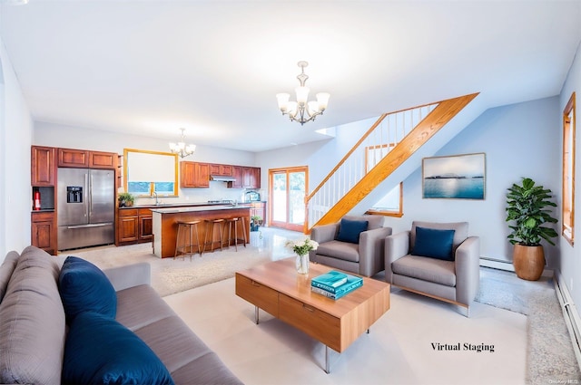 living room with a notable chandelier, baseboard heating, and sink