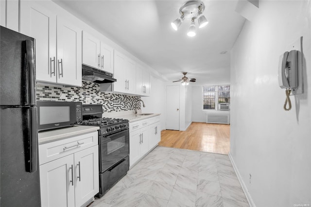 kitchen with black appliances, ceiling fan, white cabinets, and sink