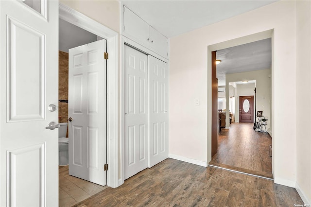 corridor with hardwood / wood-style flooring