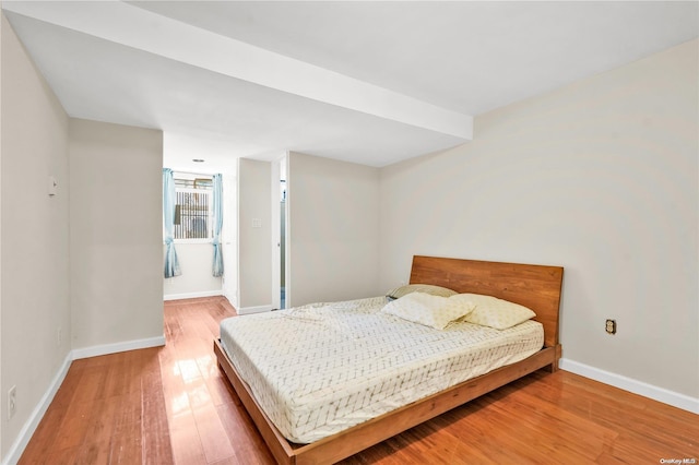 bedroom with hardwood / wood-style flooring