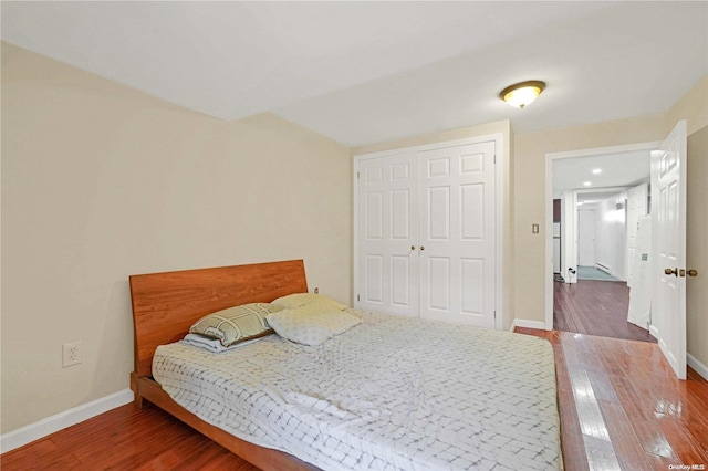 bedroom with a closet and dark wood-type flooring