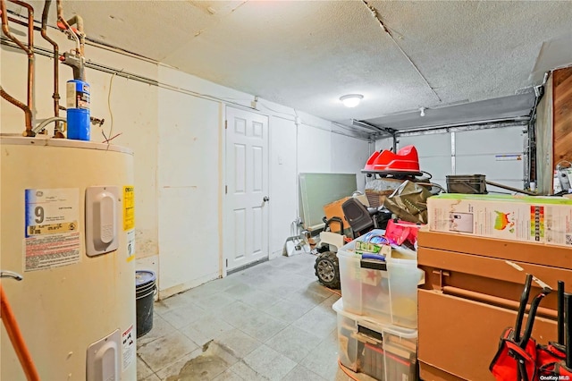 basement with electric water heater and a textured ceiling