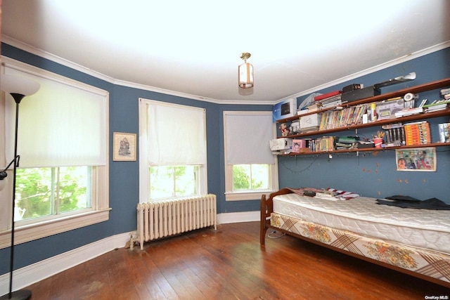 bedroom featuring radiator, dark wood-type flooring, multiple windows, and ornamental molding