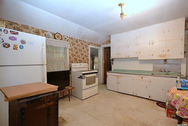 kitchen with vaulted ceiling, white cabinetry, sink, and white appliances