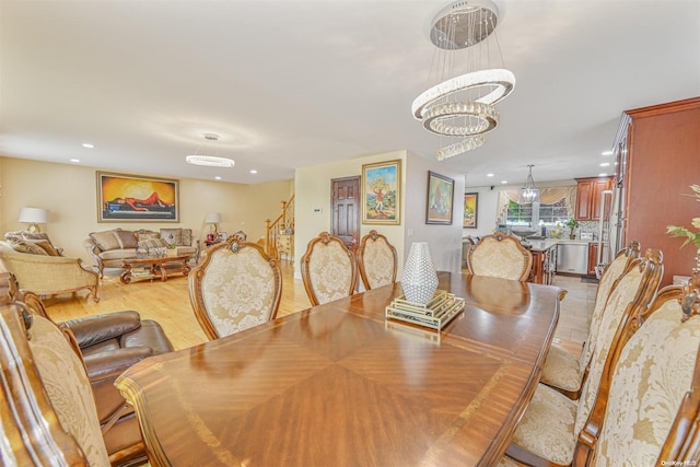 dining room featuring light wood-type flooring and a notable chandelier